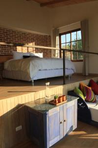 a bedroom with a bed and a table in front of it at Wayarumi Skyhotel in Carhuaz