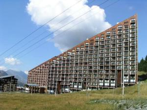a large building in the middle of a field at Résidence Caron - Appartement lumineux pour 3 personnes MAE-5824 in Les Menuires +10 photos