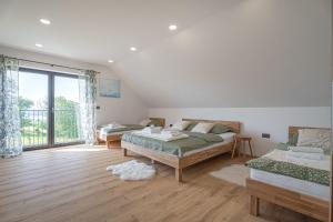 a bedroom with two beds and a large window at Wellness Villa Vinita in Sveti Jurij ob Ščavnici +38 photos