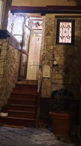 a stone house with stairs and a window at Coven Shabby Apartment, il tuo rifugio nel cuore della città in Benevento +16 photos