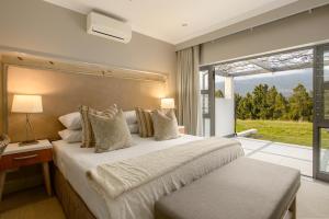 a bedroom with a large bed and a large window at Stellenbosch Luxury Apartments in Stellenbosch +94 photos