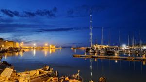 a group of boats docked in a marina at night at Il porto è di casa in Trani
