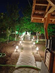 a pathway with lights in a park at night at Chergata Guest House in Zheglitsa