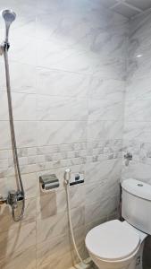 a bathroom with a toilet and a shower at Luluat Al Badaie Hotel in Makkah +27 photos