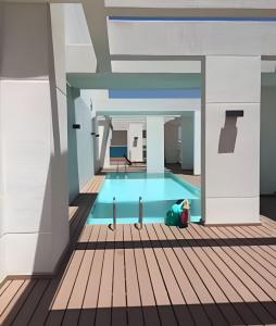 a person sitting in a pool in a building at Exclusive and Secure Apartment Parque Arauco Las Condes in Santiago