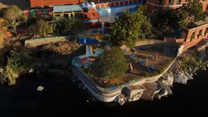 an aerial view of a miniature park next to the water at Cataract Nile View Rooms in Shellal