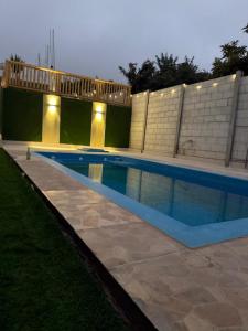 a swimming pool with lights next to a building at La Casa Bella De Lunahuana in Lunahuaná