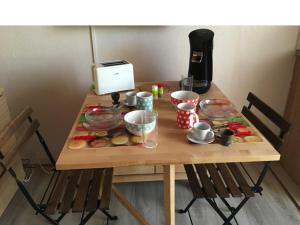 a wooden table with food on top of it at le studio du lac in Annecy +2 photos