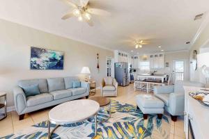 a living room with a couch and a table at Midsummer Solstice in Dauphin Island