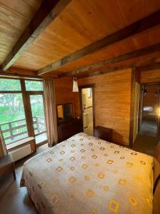a bedroom with a bed in a room with wooden walls at Villa Fox Bakuriani in Bakuriani