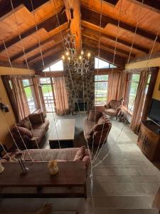 a living room with a couch and a chandelier at Villa Fox Bakuriani in Bakuriani