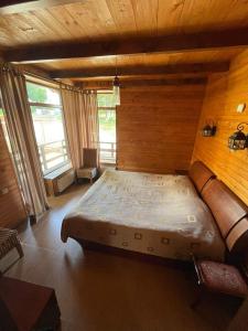 a bedroom with a bed in a room with wooden walls at Villa Fox Bakuriani in Bakuriani +8 photos