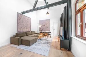 a living room with a couch and a tv at Mitte Loft group & family friendly, 150m2, 2BRs, 2Bathrooms, living & dinning room , 4 - 8 Guests in Berlin +17 photos