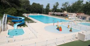 a large pool with a slide and a water park at Appartement 200m plages in Six-Fours-les-Plages