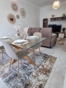 a living room with a glass table and a couch at Apartamento Brisa in Viana do Castelo