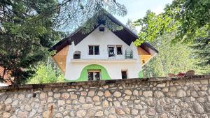 a house on top of a stone wall at Blueberry Mountain House in Žabljak
