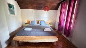 a bedroom with a large bed with blue pillows at Blueberry Mountain House in Žabljak
