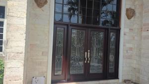 a black front door with a wrought iron gate at Villa Ornella in Tela