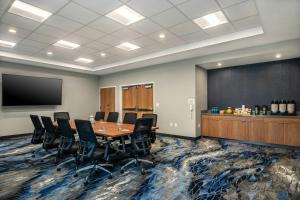 a conference room with a table and chairs and a blackboard at Fairfield by Marriott Inn & Suites Gravenhurst Muskoka in Gravenhurst +73 photos