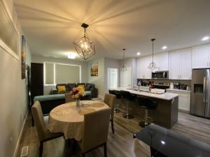 Una cocina y una sala de estar con una mesa en una habitación. en Greensville Suites, en Regina