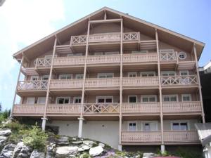 a large building with balconies on the side of it at Résidence Chateaux De Crans - Studio lumineux · Balcon MAE-8264 in Magland +9 photos