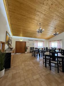 a dining room with tables and chairs and a wooden ceiling at Herdade Monte Gordo in Ourique