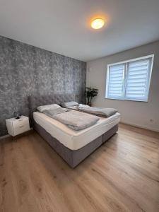 a bedroom with a large bed in a room at Ferienwohnung NOVA 1 Merzig - Brotdorf in Merzig