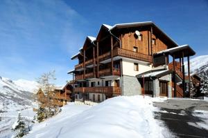 ein Gebäude auf einem schneebedeckten Berg mit in der Unterkunft Résidence Les Cristaux - Appartement spacieux · Proche des pistes · Balcon · Sauna · Hammam · WIFI MAE-0604 in Levassaix