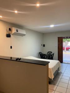 a hotel room with a bed and a air conditioner at Flat Praia do Pontal in Baía Formosa