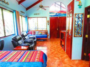 a living room with a couch and a chair at Casa Azul with Private Pool - Tropical Oasis - WiFi-AC-Bikes-Surfboards- Walk to point in Pavones +50 photos