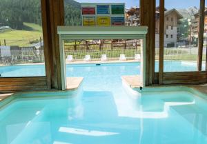 a swimming pool with a view of a mountain at Résidence Les Hauts De Preclaux - Studio rénové au coeur des Orres 1800 MAE-6234 in Les Orres +13 photos