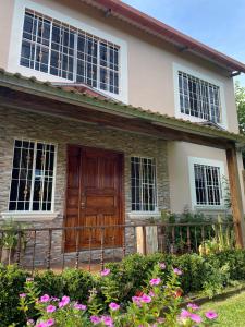 una casa con una porta in legno e alcuni fiori di La Casa de Sonya a Concepción de Ataco