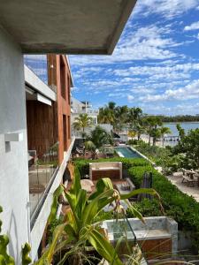a balcony of a building with a view of the ocean at Beachfront 3BR Condo with Private Rooftop and lounge pool, Tankah Bay in Tulum