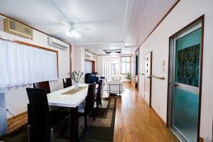 a dining room with a table and chairs at Velvet House in Murokawa