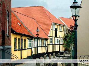 a row of houses with orange roofs and a street light at 8 person holiday home on a holiday park in Bogense in Bogense +63 photos