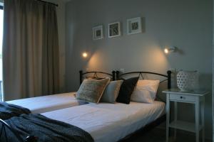 a bedroom with two beds with pillows on it at Vasilina in Faliraki