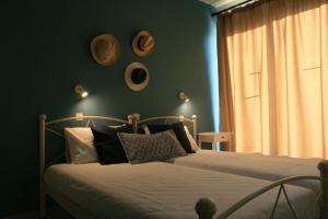 a bedroom with a bed with black and white pillows at Vasilina in Faliraki