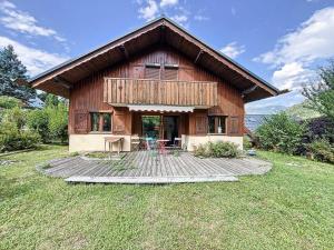 a wooden house with tables and chairs in front of it at Chalet Les Elfes - Chalet Les Elfes — Luxe et confort pour un séjour MAE-7361 in Les Allues