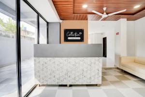 a lobby with a waiting area with a ceiling fan at Super Collection O Omkar Nagar Nagpur in Nagpur