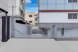 a white gate in front of a building at Super Collection O Omkar Nagar Nagpur in Nagpur +43 photos