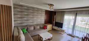 a living room with a couch and a television at Azha Sokhna private villa in Ain Sokhna