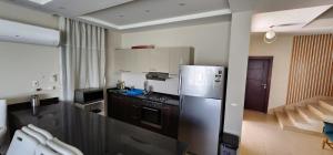 a kitchen with a stainless steel refrigerator and a stove at Azha Sokhna private villa in Ain Sokhna