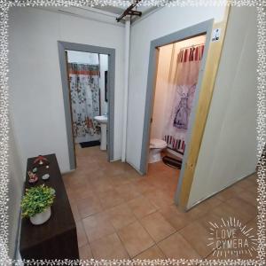 a hallway with a bathroom with a toilet and a sink at Patagonia Mágica in Punta Arenas
