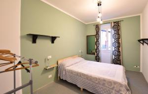 a small bedroom with a bed and a window at 2 Bedroom Awesome Apartment In Cinte Tesino in Cinte Tesino +6 photos