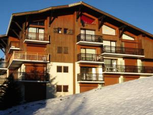 an apartment building with snow in front of it at Résidence Le Chambet - Studio calme avec jardin MAE-3354 in Notre-Dame-de-Bellecombe