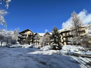 a large apartment building covered in snow at Résidence Cretes - Studio + alcôve centre village MAE-0224 in Le Monêtier-les-Bains +5 photos