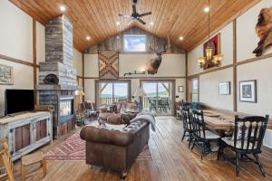 a living room with a couch and a table and a fireplace at Red Mountain Ranch- Bitterroot Mountain Views in Victor