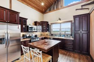 a kitchen with a wooden table and a refrigerator at Red Mountain Ranch- Bitterroot Mountain Views in Victor