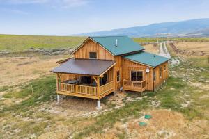 an overhead view of a wooden house in a field at Red Mountain Ranch- Bitterroot Mountain Views in Victor