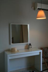 a mirror on top of a white table in a room at Vasilina in Faliraki